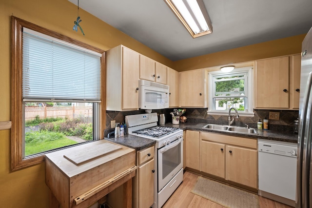 967 Stryker Ave W, Saint Paul, MN 55118 - kitchen with white appliances, light brown cabinets, dark countertops, and backsplash