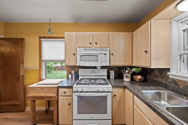 967 Stryker Ave W, Saint Paul, MN 55118 - kitchen with white appliances, light brown cabinetry, dark countertops, backsplash, and light wood-style floors