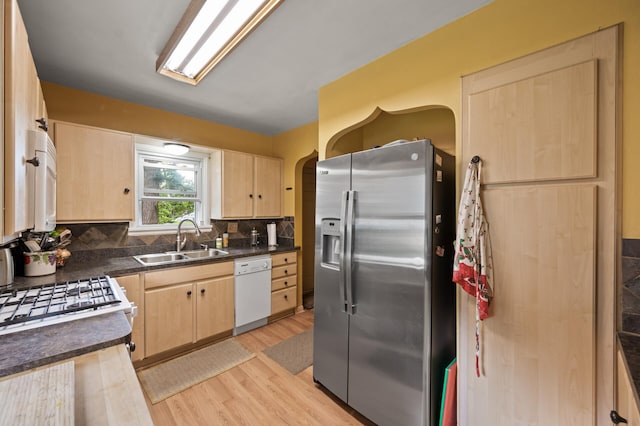 967 Stryker Ave W, Saint Paul, MN 55118 - kitchen with stainless steel fridge, light brown cabinets, white dishwasher, and arched walkways