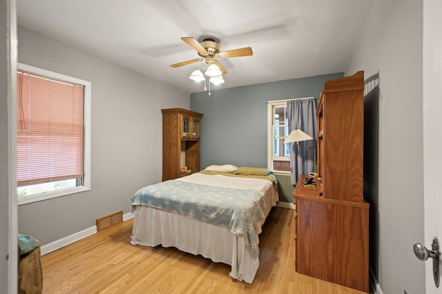 967 Stryker Ave W, Saint Paul, MN 55118 - bedroom with multiple windows, light wood-type flooring, and a ceiling fan