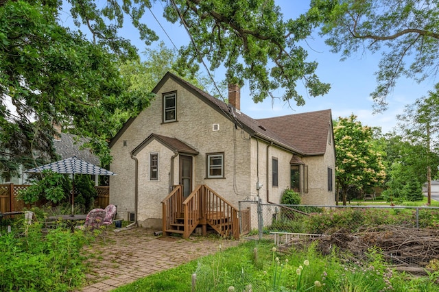 967 Stryker Ave W, Saint Paul, MN 55118 - view of front of home with stucco siding, a chimney, and a shingled roof