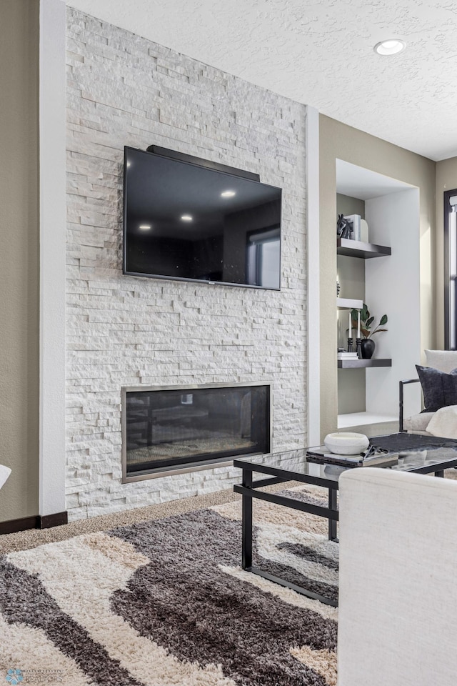 2800 Mcleod Dr E, West Fargo, ND 58078 - living room featuring a fireplace, a textured ceiling, and built in features