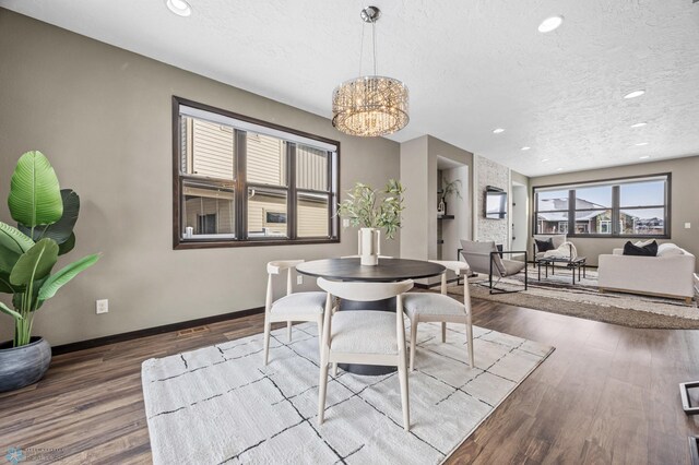 2800 Mcleod Dr E, West Fargo, ND 58078 - dining room with a textured ceiling, a chandelier, wood finished floors, baseboards, and recessed lighting
