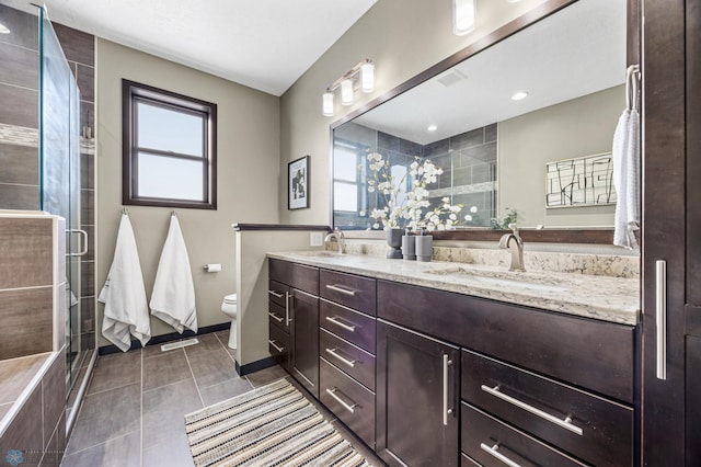 2800 Mcleod Dr E, West Fargo, ND 58078 - full bath featuring double vanity, plenty of natural light, a shower stall, and toilet