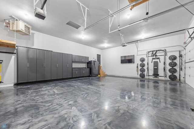 2800 Mcleod Dr E, West Fargo, ND 58078 - garage with freestanding refrigerator and a garage door opener