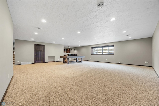 2800 Mcleod Dr E, West Fargo, ND 58078 - below grade area featuring light colored carpet, baseboards, a textured ceiling, and recessed lighting