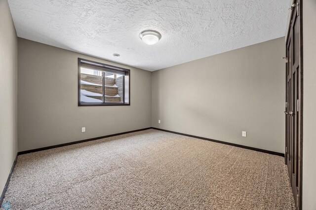 2800 Mcleod Dr E, West Fargo, ND 58078 - carpeted empty room featuring a textured ceiling and baseboards