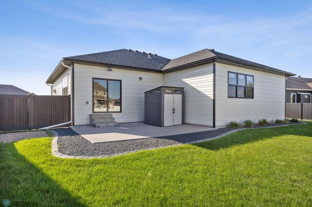 2800 Mcleod Dr E, West Fargo, ND 58078 - back of house featuring a patio, a shingled roof, and entry steps