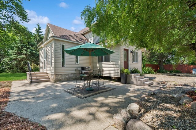 6198 210th Ave SE, Lake Lillian Twp, MN 56253 - rear view of house featuring roof with shingles and a patio area