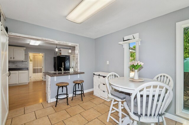6198 210th Ave SE, Lake Lillian Twp, MN 56253 - dining space with plenty of natural light, light tile patterned floors, and baseboards