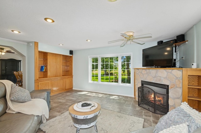 6198 210th Ave SE, Lake Lillian Twp, MN 56253 - living area with a ceiling fan, a fireplace, baseboards, recessed lighting, and stone finish floors