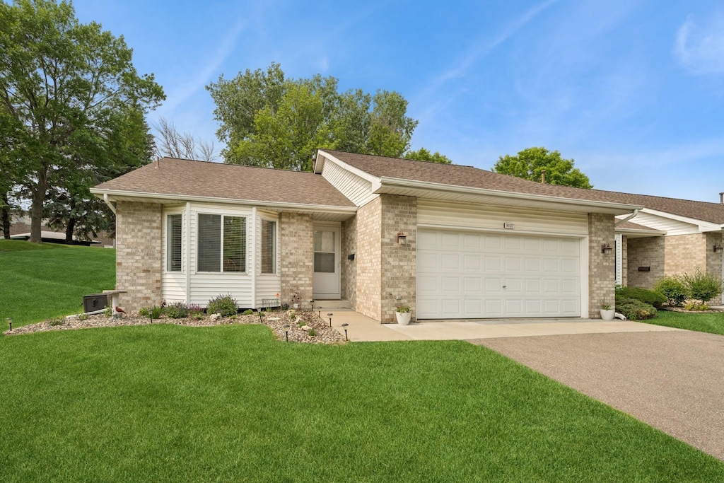 14127 141st St W, Apple Valley, MN 55124 - single story home with concrete driveway, brick siding, an attached garage, a front yard, and roof with shingles