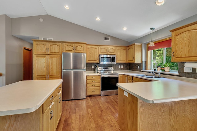 2821 15th Ave S, Saint Cloud, MN 56301 - kitchen featuring appliances with stainless steel finishes, a sink, lofted ceiling, light wood-type flooring, and light countertops