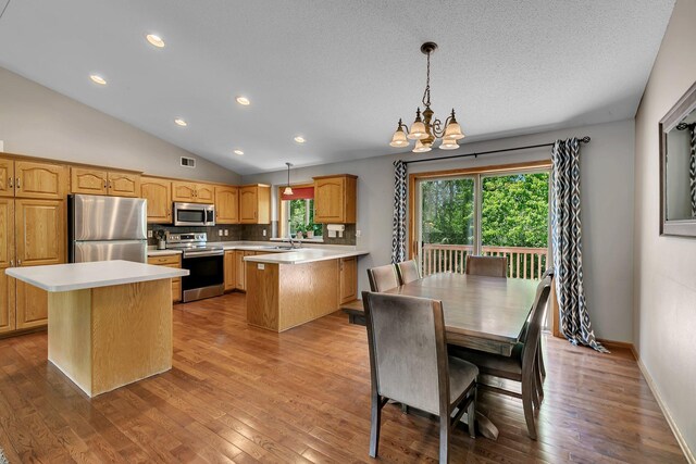 2821 15th Ave S, Saint Cloud, MN 56301 - kitchen featuring stainless steel appliances, a sink, light countertops, vaulted ceiling, and a peninsula