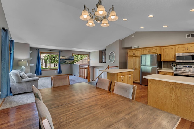 2821 15th Ave S, Saint Cloud, MN 56301 - dining room with a chandelier, vaulted ceiling, wood finished floors, and recessed lighting