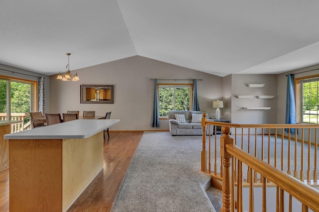 2821 15th Ave S, Saint Cloud, MN 56301 - kitchen with wood finished floors, lofted ceiling, light countertops, a center island, and a chandelier