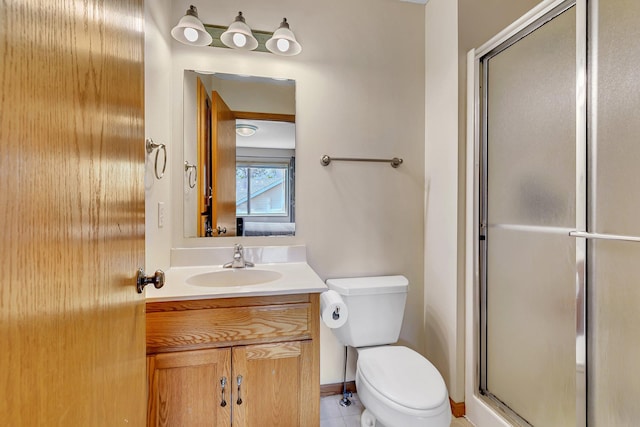 2821 15th Ave S, Saint Cloud, MN 56301 - bathroom with vanity, a stall shower, toilet, tile patterned flooring, and baseboards