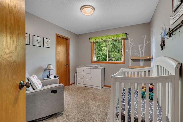 2821 15th Ave S, Saint Cloud, MN 56301 - bedroom featuring carpet floors, a crib, a textured ceiling, and baseboards