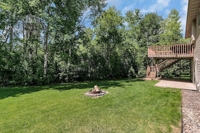2821 15th Ave S, Saint Cloud, MN 56301 - view of grassy yard with an outdoor fire pit, stairs, and a wooden deck