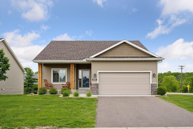 6052 Iris Ln, Rockford, MN 55373 - craftsman-style home with a front yard, asphalt driveway, a garage, and stone siding