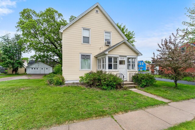 208 2nd St SW, Braham, MN 55006 - traditional-style house featuring a front yard, a detached garage, and an outdoor structure