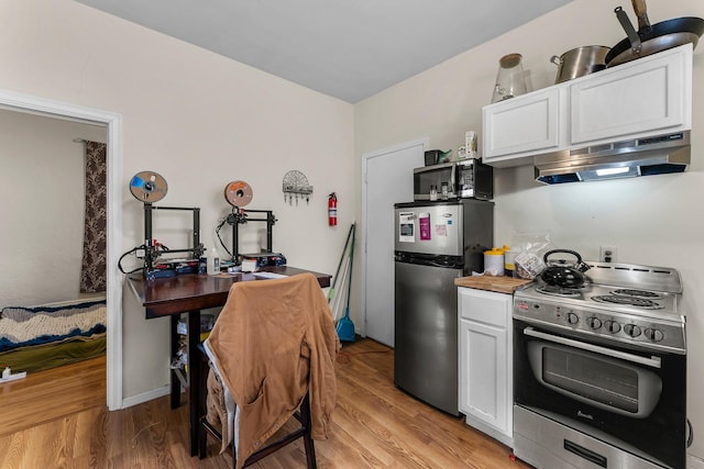 208 2nd St SW, Braham, MN 55006 - kitchen with appliances with stainless steel finishes, range hood, white cabinets, and light wood finished floors