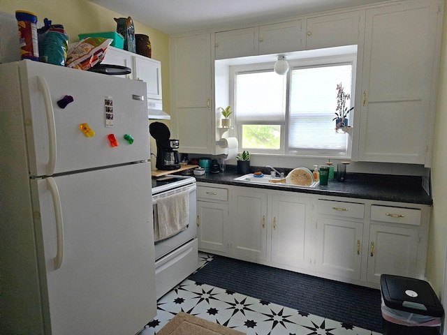 208 2nd St SW, Braham, MN 55006 - kitchen with white appliances, extractor fan, dark countertops, and white cabinets