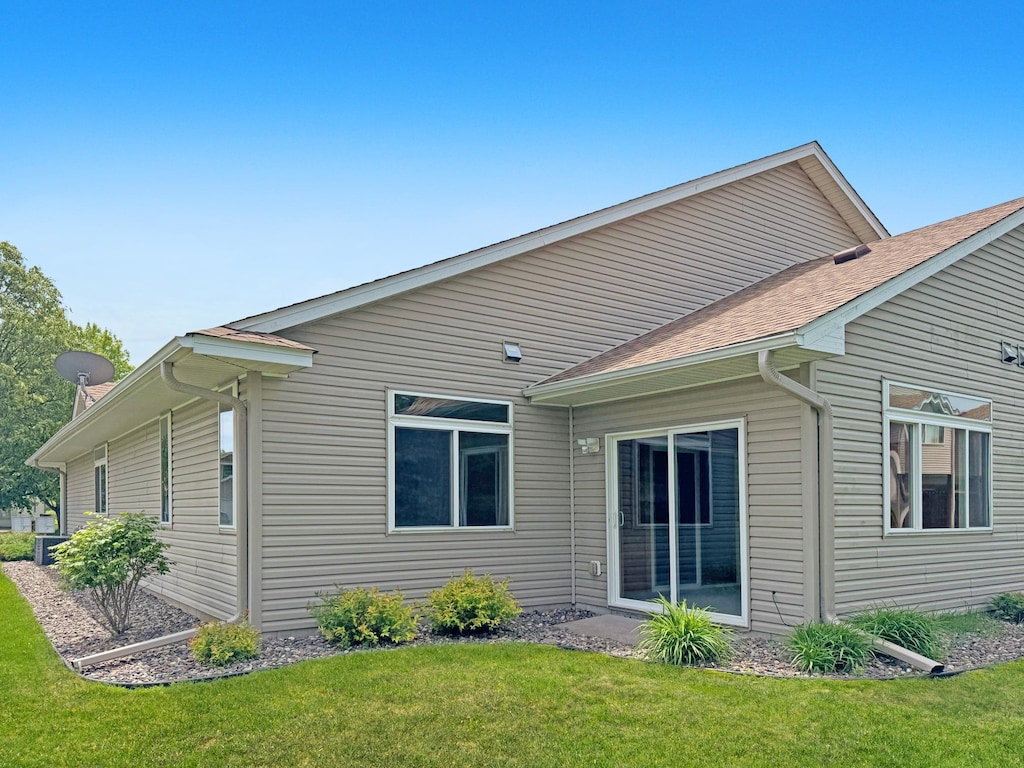 10783 Tyler Ct NE, Blaine, MN 55434 - rear view of property with a lawn and roof with shingles