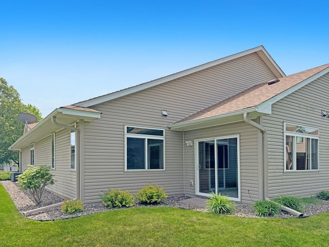 10783 Tyler Ct NE, Blaine, MN 55434 - rear view of property with a lawn and roof with shingles