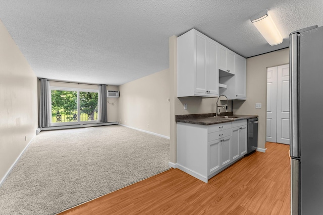 179 Little Canada Rd E Unit 230, Little Canada, MN 55117 - kitchen featuring freestanding refrigerator, a sink, open floor plan, white cabinetry, and a wall mounted AC