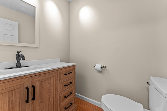 179 Little Canada Rd E Unit 230, Little Canada, MN 55117 - half bath featuring toilet, vanity, wood finished floors, and baseboards
