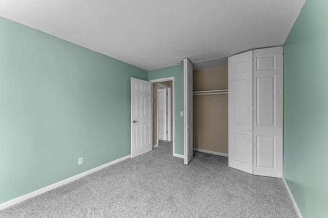 179 Little Canada Rd E Unit 230, Little Canada, MN 55117 - unfurnished bedroom with carpet flooring, baseboards, a textured ceiling, and a closet