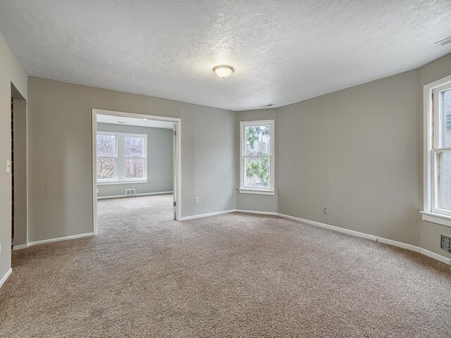 818 Edmund Ave, Saint Paul, MN 55104 - unfurnished room with a textured ceiling, carpet flooring, and baseboards