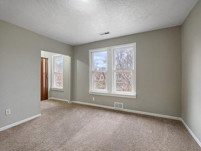 818 Edmund Ave, Saint Paul, MN 55104 - carpeted spare room featuring a textured ceiling and baseboards