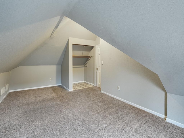 818 Edmund Ave, Saint Paul, MN 55104 - bonus room with vaulted ceiling, carpet, baseboards, and a textured ceiling