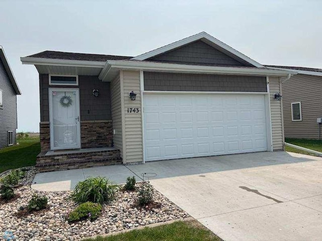1743 46th Ave S, Moorhead, MN 56560 - ranch-style house with driveway, a garage, central air condition unit, and stone siding