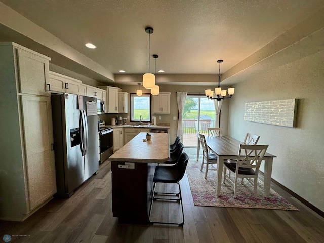 1743 46th Ave S, Moorhead, MN 56560 - kitchen with stainless steel appliances, a sink, dark wood finished floors, white cabinets, and recessed lighting
