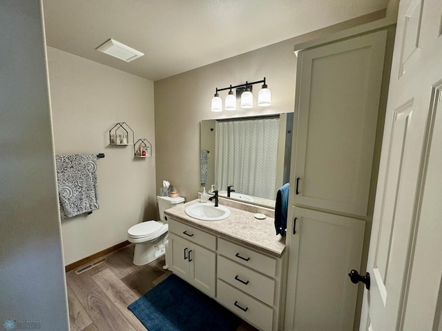 1743 46th Ave S, Moorhead, MN 56560 - bathroom with vanity, wood finished floors, toilet, and baseboards