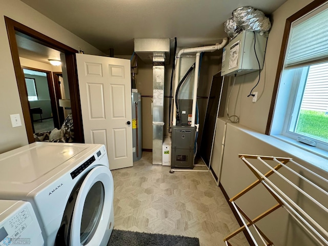 1743 46th Ave S, Moorhead, MN 56560 - laundry area featuring washing machine and clothes dryer, water heater, light flooring, and heating unit