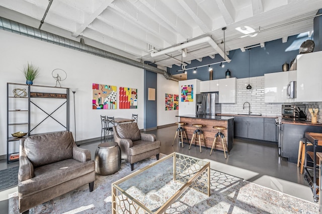 111 Franklin Ave Unit 105, Minneapolis, MN 55404 - living area featuring finished concrete flooring and a towering ceiling
