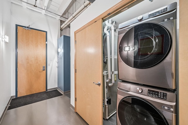 111 Franklin Ave Unit 105, Minneapolis, MN 55404 - laundry room with stacked washing machine and dryer and baseboards