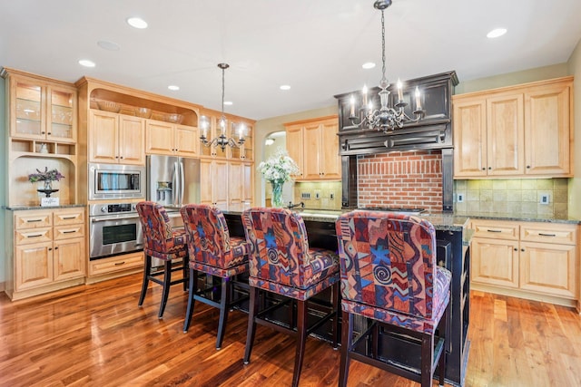 15758 Austin St NE, Ham Lake, MN 55304 - kitchen with a chandelier, stainless steel appliances, light brown cabinets, light wood-style floors, and recessed lighting
