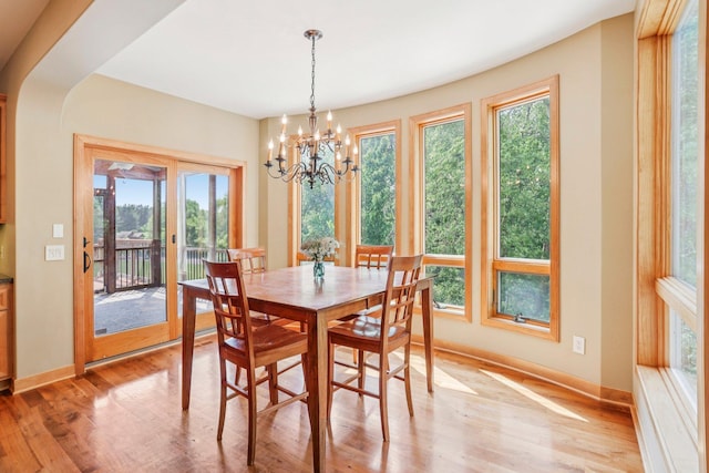 15758 Austin St NE, Ham Lake, MN 55304 - dining room featuring plenty of natural light, light wood-style floors, and a chandelier