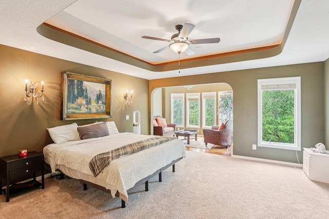 15758 Austin St NE, Ham Lake, MN 55304 - carpeted bedroom featuring a tray ceiling and ceiling fan