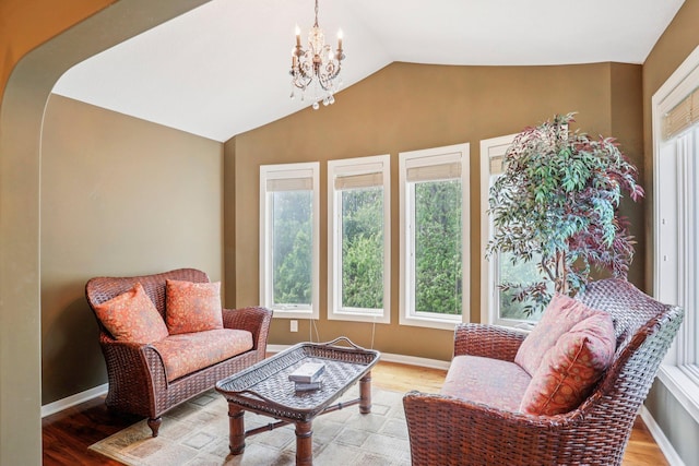 15758 Austin St NE, Ham Lake, MN 55304 - living area featuring healthy amount of natural light, a chandelier, light wood finished floors, and vaulted ceiling