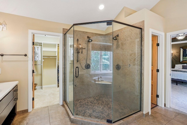 15758 Austin St NE, Ham Lake, MN 55304 - ensuite bathroom featuring vanity, a spacious closet, a shower stall, tile patterned flooring, and recessed lighting