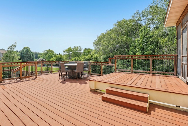 15758 Austin St NE, Ham Lake, MN 55304 - wooden terrace featuring outdoor dining space and view of scattered trees