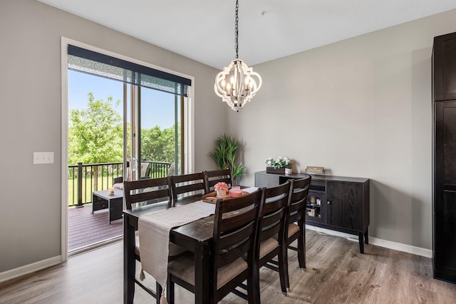 14834 Willemite Way NW, Ramsey, MN 55303 - dining area with a chandelier, light wood-style flooring, and baseboards