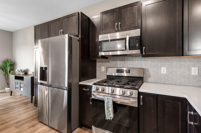 14834 Willemite Way NW, Ramsey, MN 55303 - kitchen with stainless steel appliances, light countertops, decorative backsplash, and light wood-style floors