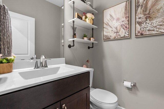 14834 Willemite Way NW, Ramsey, MN 55303 - bathroom featuring vanity, toilet, and baseboards